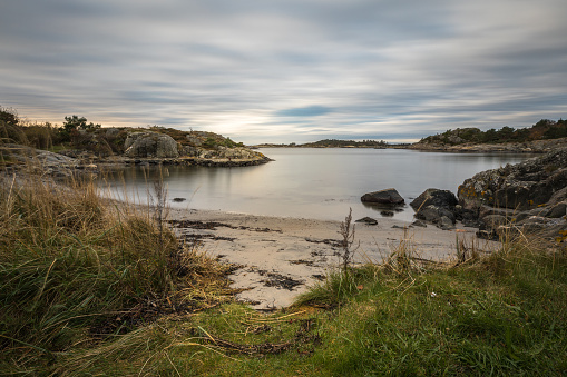 Seascape with rocks, sea and clouds. Grimstad in Norway in autumn