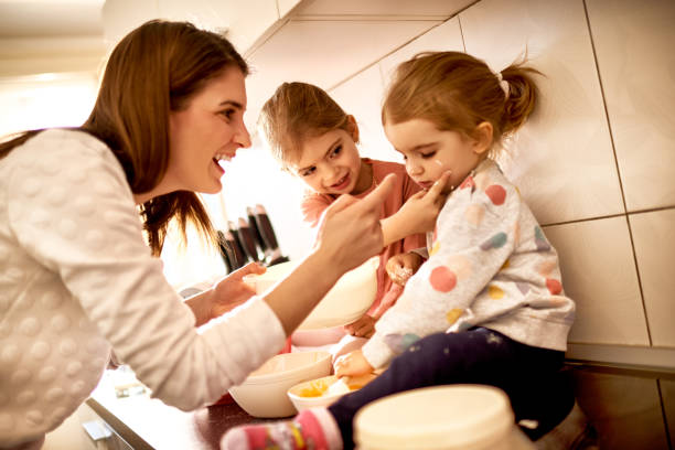 istock Mother with daughters in the kitchen 871805700