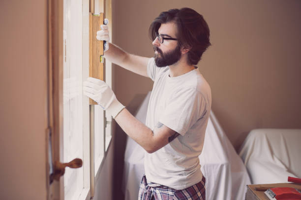 istock Young man repairing window at home 871815602
