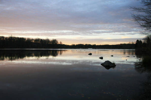 istock Beautiful forest lake sunrise in November. 871815702