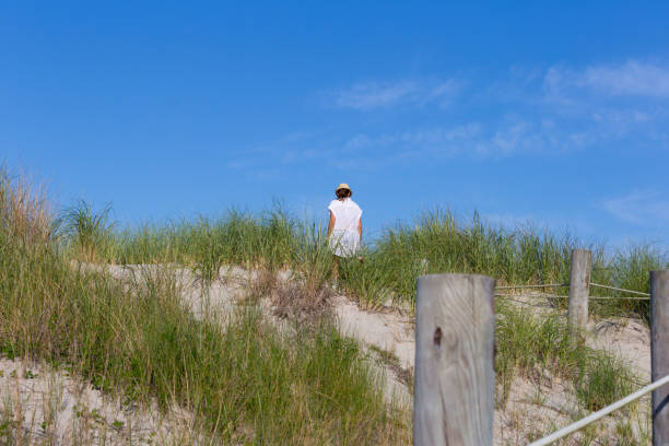 istock Women walking in sand dune 871819034