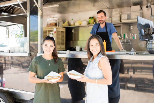 istock Women eating hot dogs 871819648