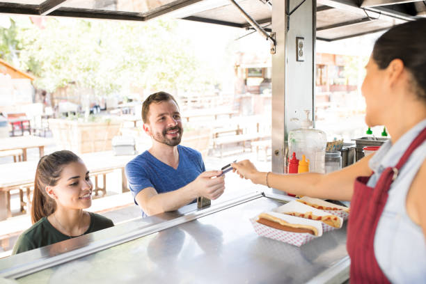 istock Man using credit card in a food truck 871819798