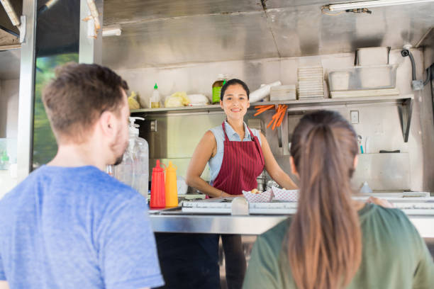 istock Food truck owner with some customers 871819964
