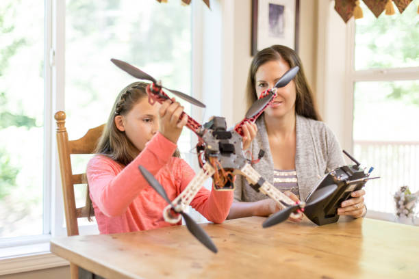 istock Mom and daughter examine a drone at the kitchen table 871820144