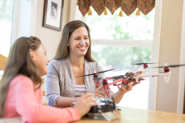 istock Mom and daughter examine a drone at the kitchen table 871820160
