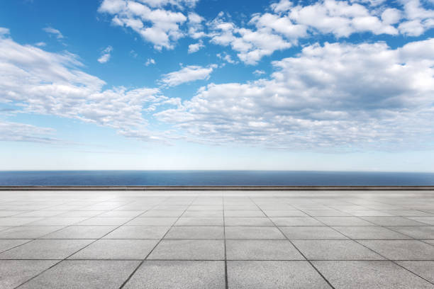 istock empty marble floor with blue sea in blue sky 871820414