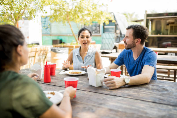 istock Friends talking and eating chinese food 871820534