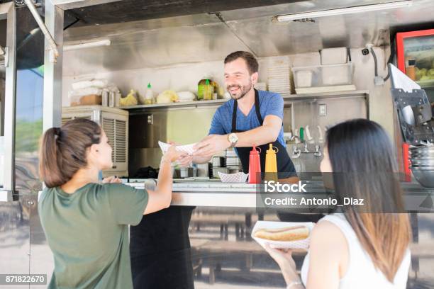 Girls Buying Hot Dogs From Food Truck Stock Photo - Download Image Now - Hot Dog, Concession Stand, Food Truck