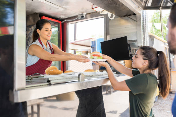 istock Woman serving food to customer 871822770