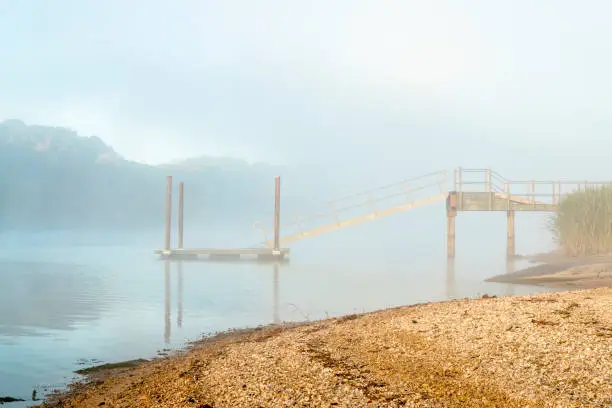 foggy fall morning at a dock and boat ramp on Tennessee River,  Colbert Ferry along Natchez Trace Parkway