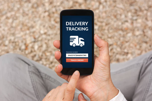 istock Hands holding smart phone with delivery tracking concept on screen 871823592