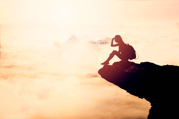 istock Woman Silhouette at sunset on hill 871824088