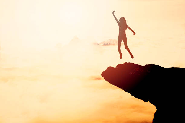 istock Woman Silhouette at sunset on hill 871824100