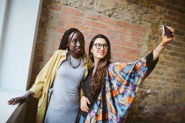 istock Young women taking a selfie before going out 871824154