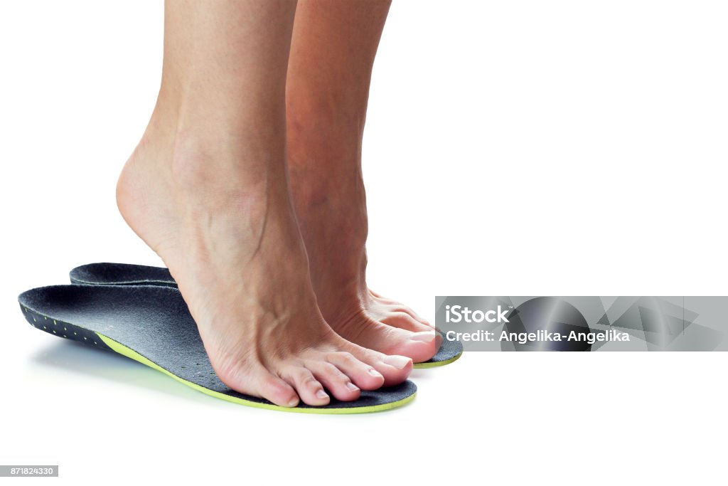 feet and orthopedic insoles female feet stand on their toes in orthopedic insoles Insoles Stock Photo