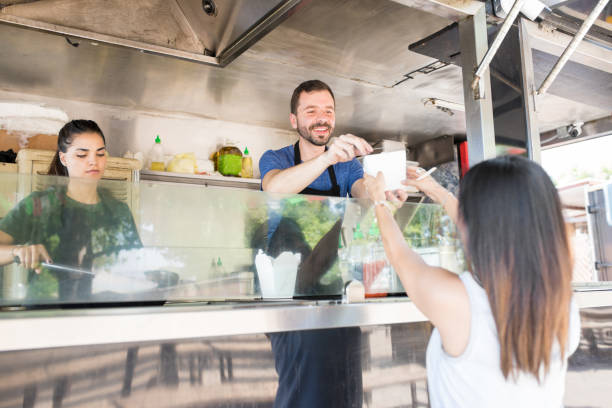 istock Man serving food to customer 871824638