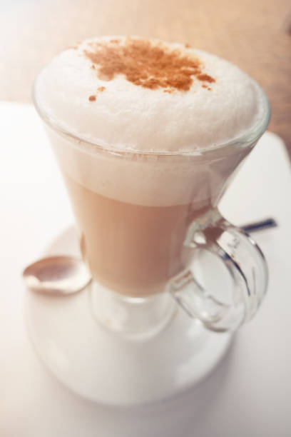 istock Close-up on a Cup of Hot Cappuccino on Table 871824974