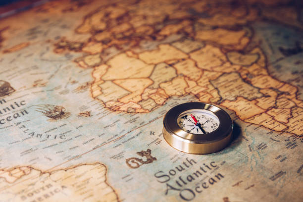 istock Old vintage retro golden compass on ancient map. Selective focus, shallow depth of field. Concept of world travel, sightseeing and tourism. 871825124