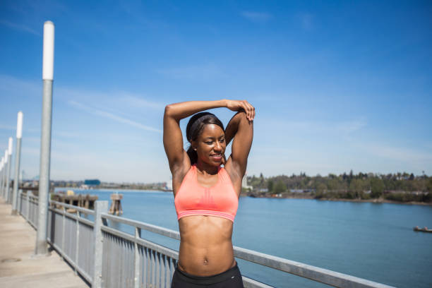 istock African American female jogger goes for a run along the river 871831204