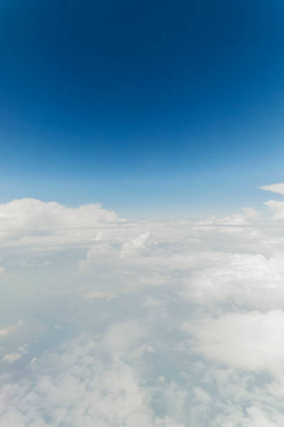 istock Clouds and Sky as Seen Through Window of an Aircraft 871831420