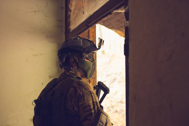 istock Soldier with rifle in the ruins 871838020
