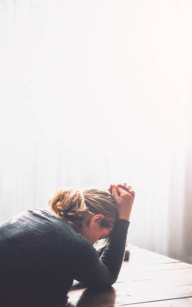 istock Stressed woman sitting in loft surrounded by bright sunlight 871844222