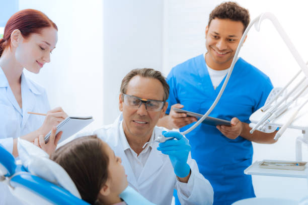 istock Delighted positive doctor treating his young patient 871847668