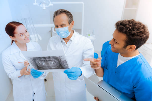 istock Delighted positive dentists discussing an X ray photo 871847848