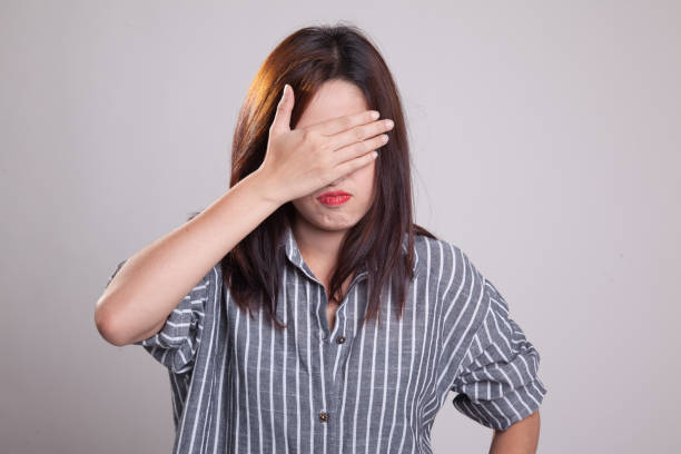 istock Young Asian woman close her eyes with hand. 871850586