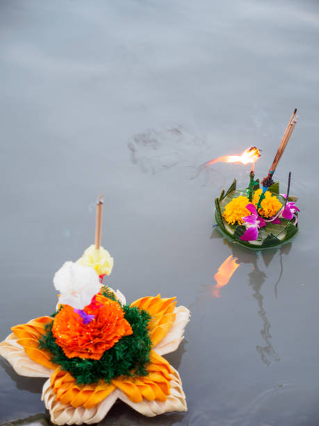 istock Multiple krathong in a lake with burning incense 871850956