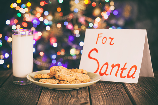 Cookies and Milk for Santa on Rustic Wooden Tabl
