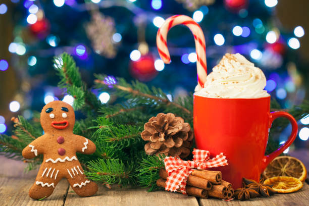 istock Christmas cappuccino and gingerbread cookies infront Christmas tree on Rustic Wooden Table 871851322