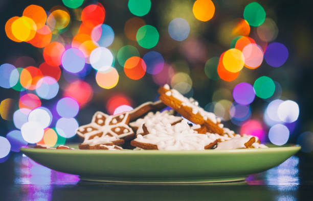 Christmas Gingerbread stars cookies infront Christmas tree. The cookies are homemade made by me and are unique and can not be found anywhere.