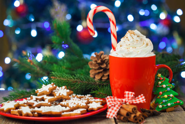 istock Christmas cappuccino and gingerbread cookies infront Christmas tree on Rustic Wooden Table 871854152