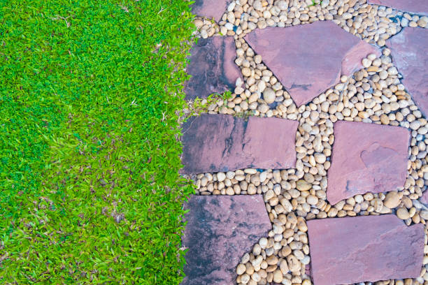 istock Green grass field with stone pathway and small rock decoration. 871854560