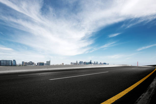 istock empty asphalt road with modern bridge and buildings 871857146