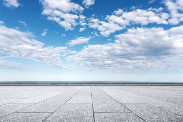 istock empty marble floor with beautiful sea in blue cloud sky 871860578