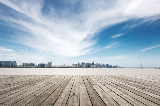 istock empty wooden floor with modern bridge and buildings 871860746