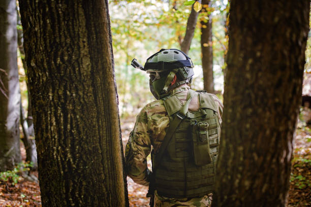 istock Airsoft player, man in camouflage with gun 871871500