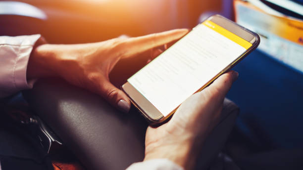 istock Female traveler using a smartphone surfing the internet while sitting in an aircraft 871874310
