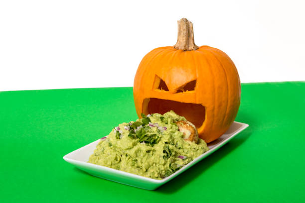 Puking Pumpkin Carved pumpkin puking guacamole from the mouth. throwing up pumpkin stock pictures, royalty-free photos & images