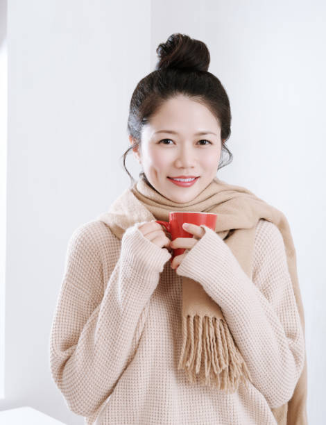 istock Woman's hand holding a red cup of coffee 871877284