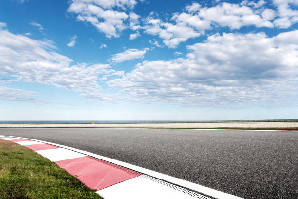 istock empty asphalt road with blue sea in blue sky 871877728