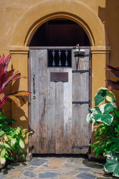 istock Old style wood door on Yellow wall 871880486