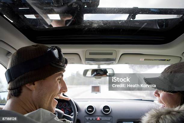 A Couple Of Skiers Laughing In A Car Stock Photo - Download Image Now - Car Interior, Driving, Happiness