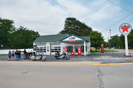 DWIGHT, IL - USA - JULY 16: Old Texaco gas station in Route 66 on July 16, 2017, in Dwight, Illinois. Group of motorcyclists resting with their motorcycles