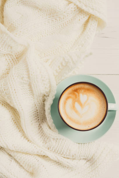 istock Winter cappuccino coffee cup on white wood background 871894018