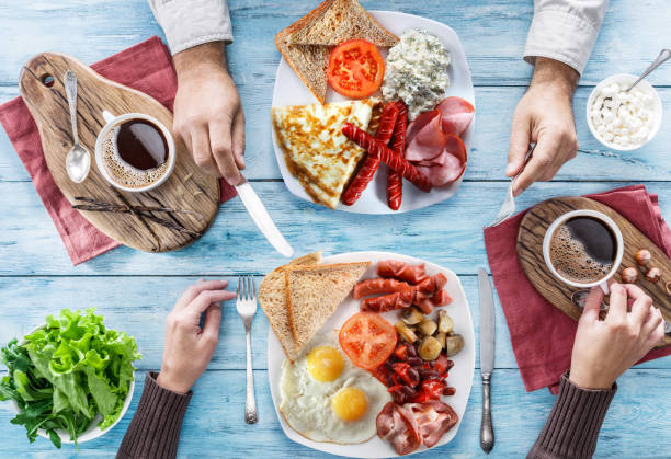 istock Traditional breakfast at home. Top view of table and people who having breakfast. 871902646