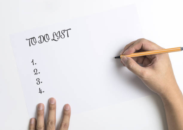 istock Hand writing down  To do List on white paper 871904904